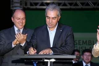Presidente da Assembleia, deputado Junior Mochi (esquerda) e o governador Reinaldo Azambuja durante solenidade assinatura de liberação de emendas. (Foto: Fernando Antunes)