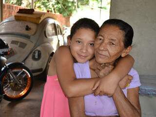 Avó e neta na casa onde Fusca permanece com 4 pneus furados há 7 anos. (Fotos: Pedro Peralta)