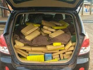 Porta-malas de veículo carregado com diversos tabletes de maconha (Foto: Divulgação/PRF)