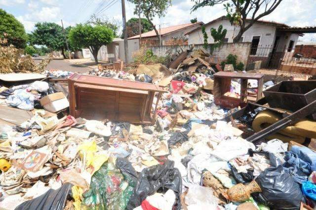 Vizinhos fazem mutir&atilde;o e lixo retirado de casa bloqueia rua