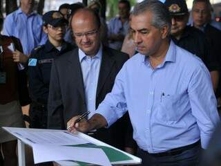 Governador Reinaldo Azambuja assinando documento com termos da parceria (Foto: Alcides Neto)