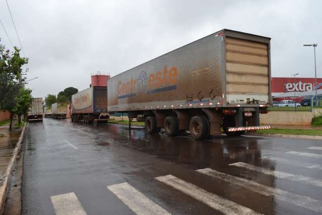 Carretas impedem fluxo de ve&iacute;culos em rua que d&aacute; acesso a supermercado