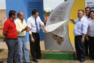 Sérgio Longen, presidente da Fiems, e prefeito de Água Clara, descerram placa de inauguração da biblioteca do Sesi na cidade.