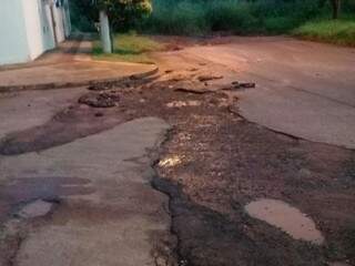 A chuva levou parte do asfalto na rua Traíra. (Foto: Direto das Ruas)