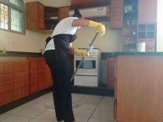 Faxineira trabalha na limpeza da cozinha de cliente; o setor de serviços foi o que mais contratou em março (Foto: Arquivo)