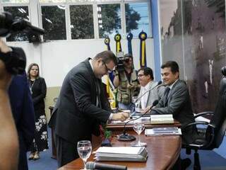 Observado por Daniela Hall e Marçal Filho, Alan Guedes assina ata após vencer eleição para comandar a Câmara (Foto: Helio de Freitas)