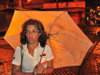 “Munida” do guarda-chuva ela ainda diz que o objeto não sai da bolsa. (Foto: João Garrigó)