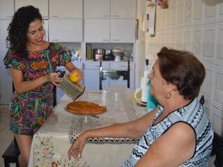 Flávia ralando uma laranja para ser detalhe do bolo da fruta, receita da avó. (Foto: Simão Nogueira)