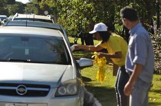 Integrantes do Movimento Maio Amarelo entregam fitinhas aos motoristas pedindo paz no trânsito. (Foto:Marcelo Calazans)