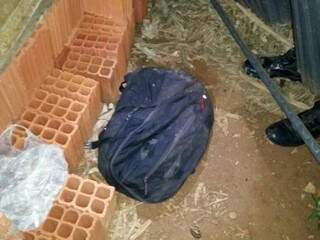 A mochila estava entre os materiais de construção nos fundos do imóvel. (Foto: Divulgação PM) 