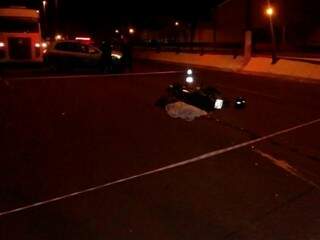 Motociclista morto ao lado da moto que pilotava pela avenida. (Foto: Direto das Ruas) 