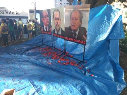 Em protesto, manifestantes jogam tomates em fotos de ministros do STF