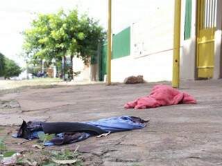 Camiseta e toalha foram encontradas na calçada de estabelecimento onde vítima foi baleada (Foto: Kísie Ainoã)
