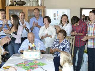 O ex-prefeito de Ponta Porã, Hélio Peluffo, sentado na mesa, na festa de 98 anos. (Foto: Divulgação)