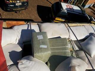 produtos eram transportados em meio a sacos de farelo de milho. (Foto: Divulgação/ PRF)