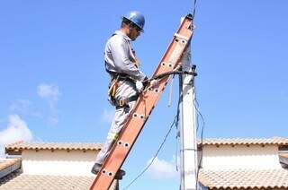 Operário confere se há furto de energia elétrica em casa (Foto: Alcides Neto)