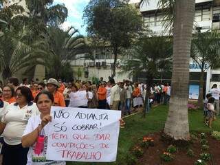 Servidora com cartaz em protesto na frente da Prefeitura de Campo Grande. (Foto: Guilherme Henri).