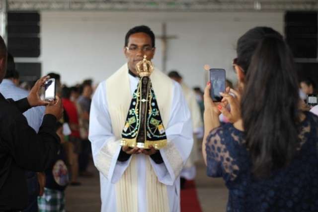 Padre Márcio dos Reis carrega imagem peregrina de Nossa Senhora. (Foto: Marcos Ermínio)