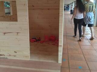 Casa de madeira exposta no corredor central da UFMS (Foto: Izabela Sanchez)