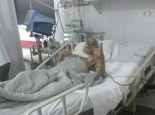 Algemado em cama de hospital, Sergio dos Santos faz sinal de positivo ao ser fotografado (Foto: Direto das Ruas)