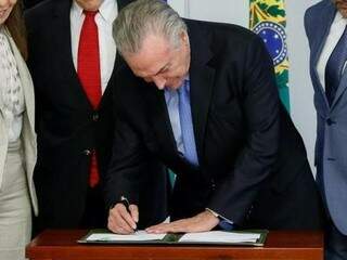 Presidente assinando decreto no Palácio do Planalto nesta quarta-feira (18) (Foto: Alan Santos/PR)