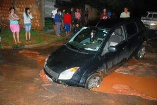 Carro caiu em buraco aberto na rua. (Foto: Umberto Zum, do Tá Na Mídia Naviraí)