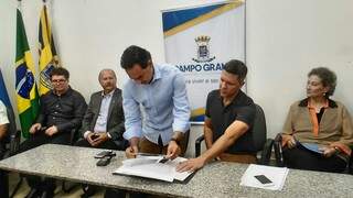 O prefeito Marquinhos Trad com o diretor da Funesp, Rodrigo Terra, e representantes das duas empresas na assinatura do convênio nesta quinta-feira (Foto: Kleber Clajus)
