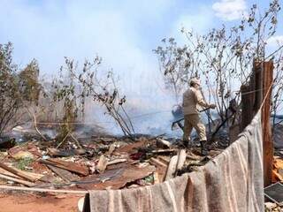 Bombeiro tenta controlar foco de incêndio próximo de barracos no Noroeste (Foto: Henrique Kawaminami)