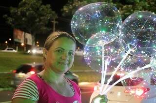 Eliane é segurança particular durante o dia e a noite vende balões luminosos que são a alegria das crianças (Foto: Kimberly Teodoro)