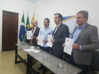 Da esquerda para direita, Evandro, da CGM, o prefeito Marquinhos Trad, José Paulo, da CGU, e Carlos Eduardo Girão, da Controladoria Geral do Estado, exibem o termo do acordo de cooperação (Foto: Anahi Gurgel)