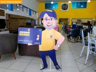 Mascote da Serrana Móveis mostra cartão de vantagens que só a loja tem. (Foto: Paulo Francis)