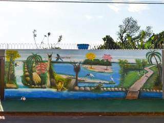 Pintura feita há um mês no muro retrata o Pantanal e a história da moradora (Foto: Alana Portela)