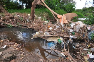 No córrego Imbirussú, o lixo atrapalha a passagem da água no local (Foto: Luciano Muta)