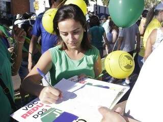 Manifestantes assinam abaixo-assinado a favor da redução dos salários dos vereadores (Foto: Alan Nantes)