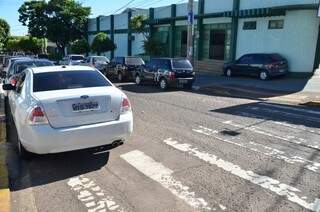 Na rua Dona Virgilina, dois carros estacionados em local proibido (Foto: Vanderlei Aparecido)