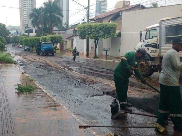 Mesmo com chuva, funcion&aacute;rios fazem tapa-buracos na Rua Sergipe