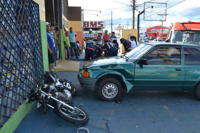  Motociclista perde controle de moto, bate em carro parado e para em janela