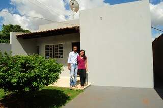 Coringa e a esposa, na porta da casa simples, no bairro Moreninha 3. (Foto: Rodrigo Pazinato)