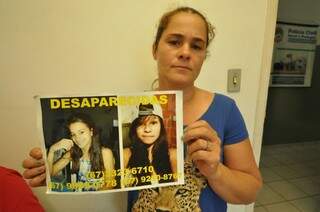 Mãe de Luana, Nicecleide mostra cartaz com fotos das desaparecidas. (Foto: Marcelo Calazans)
