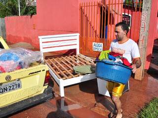 Morador carregas roupas molhadas e deixa cama e fogão para “secar” na calçada (Foto: João Garrigó)