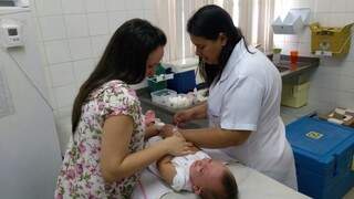 Enfermeira aplica vacina em criança em posto de saúde. (Foto: Divulgação/PMCG)