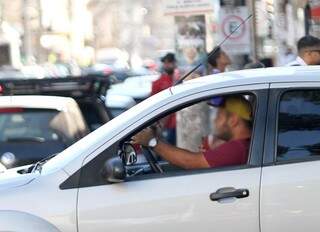 Condutor usa celular enquanto dirige pela Afonso Pena. (Foto: Saul Schramm)