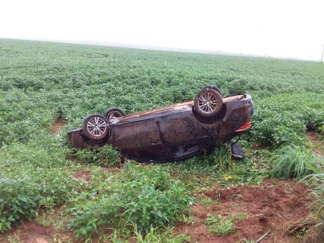 Carro aquaplana e capota em lavoura com tr&ecirc;s adultos e beb&ecirc;