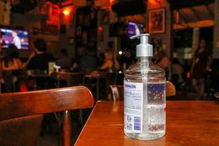 Tem álcool gel disponível em algumas mesas do Bar Merceraria. (Foto: Henrique Kawaminami)