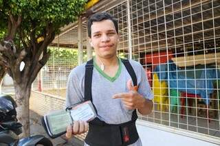 Contente, Alexandre Neves dos Santos Silva mostra a carteira que conseguiu recuperar. (Foto: Paulo Francis)