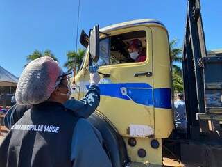 Motorista de caminhão sendo abordado na barreira sanitária do município. (Foto: Divulgação)