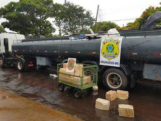 Fardos de maconha são retirados de caminhão-tanque apreendido na fronteira (Foto: Divulgação)