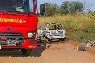 Viatura do Corpo de Bombeiros ao lado de carro encontrao queimado, na manhã de hoje, em rua sem asfalto no Parque Lageado, na Capital (Foto: Marcos Maluf)