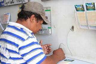 Morador marcando os números da sorte em cartela da Mega-Sena. (Foto: Arquivo) 