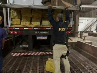 Policial rodoviário federal com a carga recorde de maconha apreendida em maio (Foto: Arquivo)